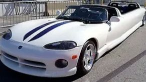 A white 1996 Dodge Viper limousine outside.