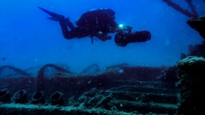 A scuba diver uses a sea scooter, also known as a diver propulsion vehicle (DPV), at a shipwreck in August 2017 outside Bonassola Liguria, Italy