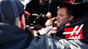 Tony Stewart sits in the driver's seat of a racecar.