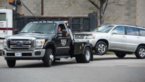 A tow truck from Advance Towing pulls a Toyota SUV in Arlington, Virginia, in 2015