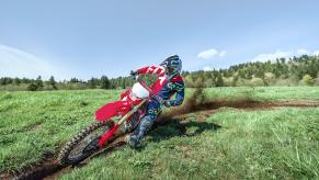 the Honda CRF450X blazing a trail in a green field