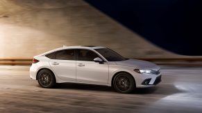 A white 2022 Honda Civic hatch photographed in a tunnel, shot in profile