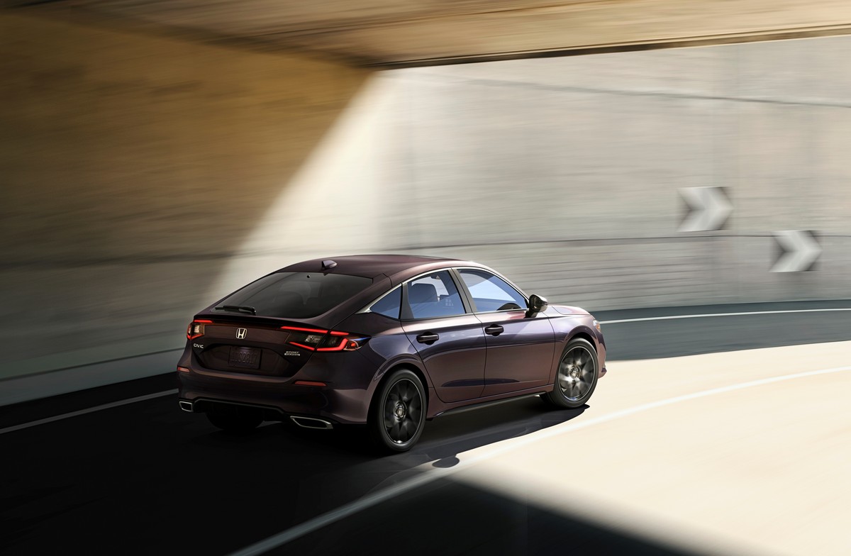 Honda civic hatchback driving under an overpass