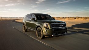 A black 2021 Kia Telluride on an open road