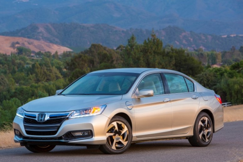 A silver 2014 Honda Accord parked on the side of a road at night.