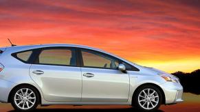 A 2014 Toyota Prius in front of a sunset and water