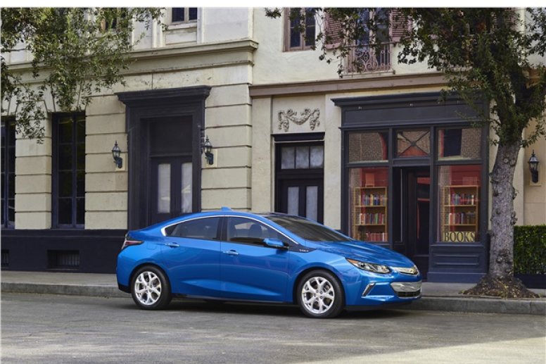 A blue 2016 Chevrolet Volt parked on the side of a road.