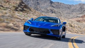 This blue 2022 Chevrolet Corvette is a direct descendant of the Chevy Corvette Indy concept, seen here from the front on a canyon road