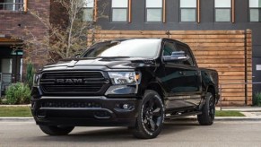 A black 2021 Ram 1500 parked outside of a house.