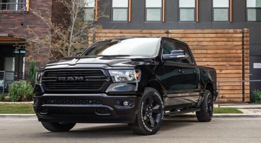 A black 2021 Ram 1500 parked outside of a house.