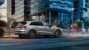 A 2021 Audi e-tron S Line Black Edition on a city street at dusk