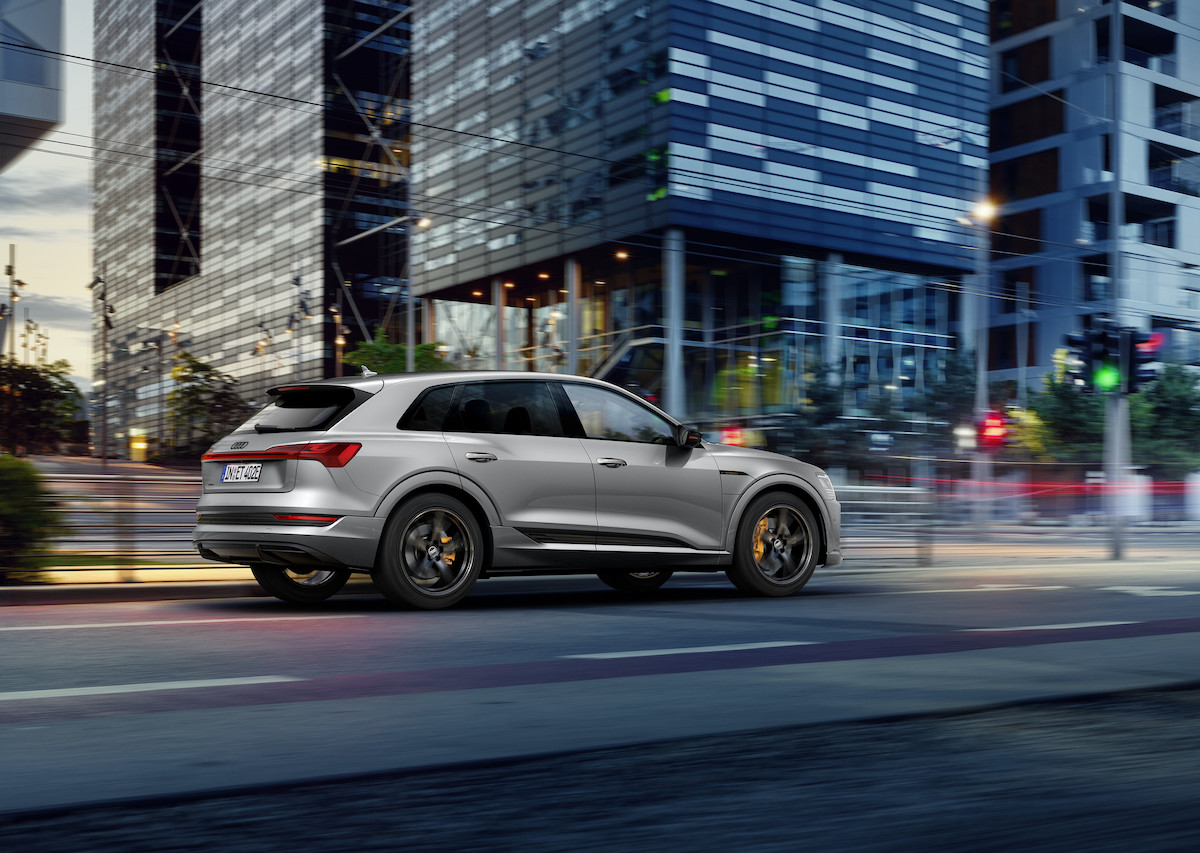 A 2021 Audi e-tron S Line Black Edition on a city street at dusk