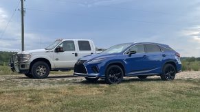 The 2021 Lexus RX 350 F Sport near a Ford F-350