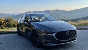 The 2021 Mazda3 Turbo in front of a mountain view