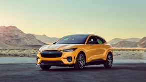 A yellow 2021 Ford Mustang Mach-E on the pavement