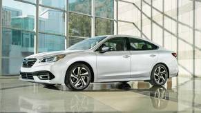 A silver 2021 Subaru Legacy parked in a showroom