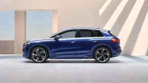 A blue 2022 Audi Q4 e-tron parked near a building