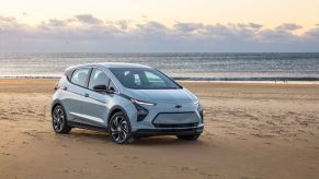 A gray 2022 Chevy Bolt EV model parked on a beach