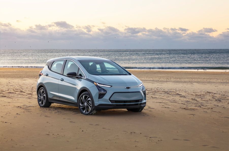 A gray 2022 Chevy Bolt EV model parked on a beach