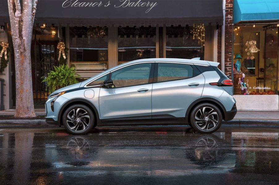 The 2022 Chevy Bolt parked on a wet downtown street