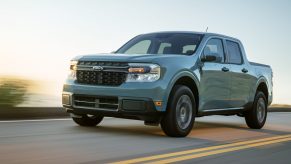 A green 2022 Ford Maverick drives on a winding road