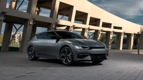 The 2022 Kia EV6 model in dark gray parked on a brick plaza