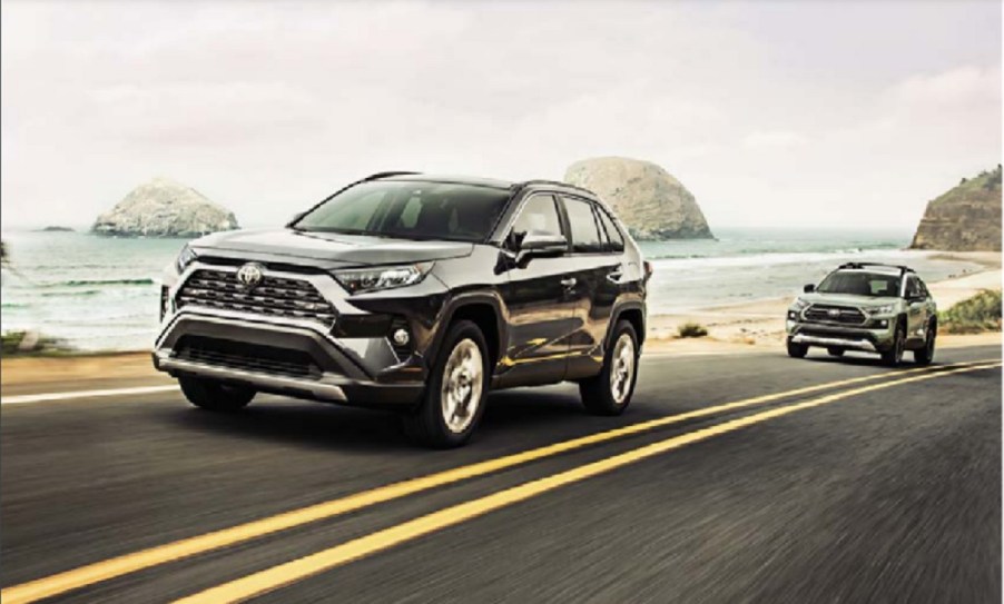 A black 2022 Toyota Rav4 driving down the coast.