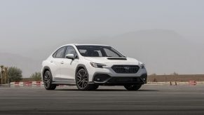 A white 2022 Subaru WRX shot from the front 3/4 on a race track