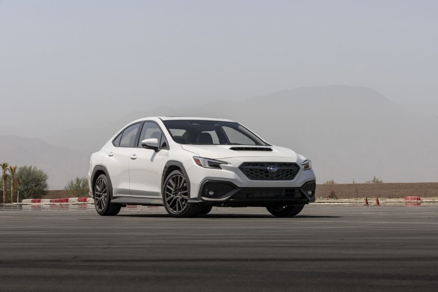 A white 2022 Subaru WRX shot from the front 3/4 on a race track