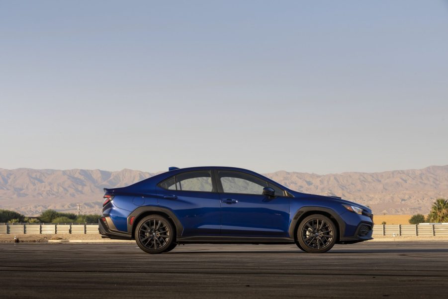 A blue 2022 Subaru WRX, shot in profile at sunset