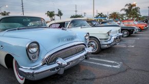 A Row Of Classic Cars Backed Into Parking Spaces