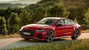 A red 2021 Audi RS7 shot from the high front 3/4 angle on a mountain road