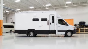 The side view of the white Advanced RV B Box 'Asteroid of Happiness' in the company's garage