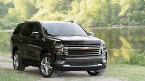 Black 2021 Chevrolet Tahoe parked next to a lake