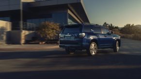 Blue 2022 Toyota 4Runner TRD Sport driving by a large building