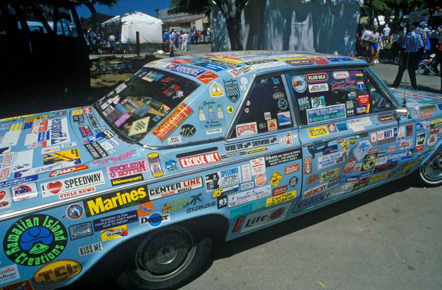 Blue car covered in bumper stickers