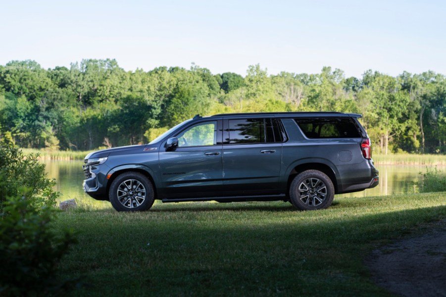 Blue-gray 2021 Chevrolet Suburban parked next to a lake