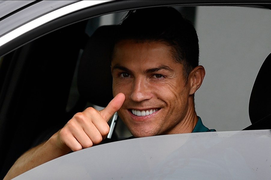 Soccer star Cristiano Ronaldo gives a thumbs-up in a car in May 2020 in Turin, Italy