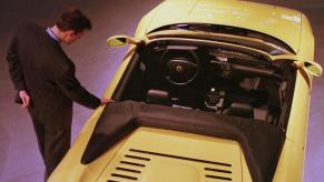 A passerby looks at a Ferrari F355 Spider at the 1998 North American International Auto Show in Detroit