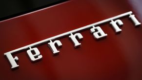 Ferrari logo for Ferrari price guide on a red car with Ferrari written in Chrome.