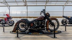 Fornarelli Motorsports' custom 2010 Harley-Davidson Fat Boy Lo next to two other custom bikes at IMS Outdoors Chicago 2021