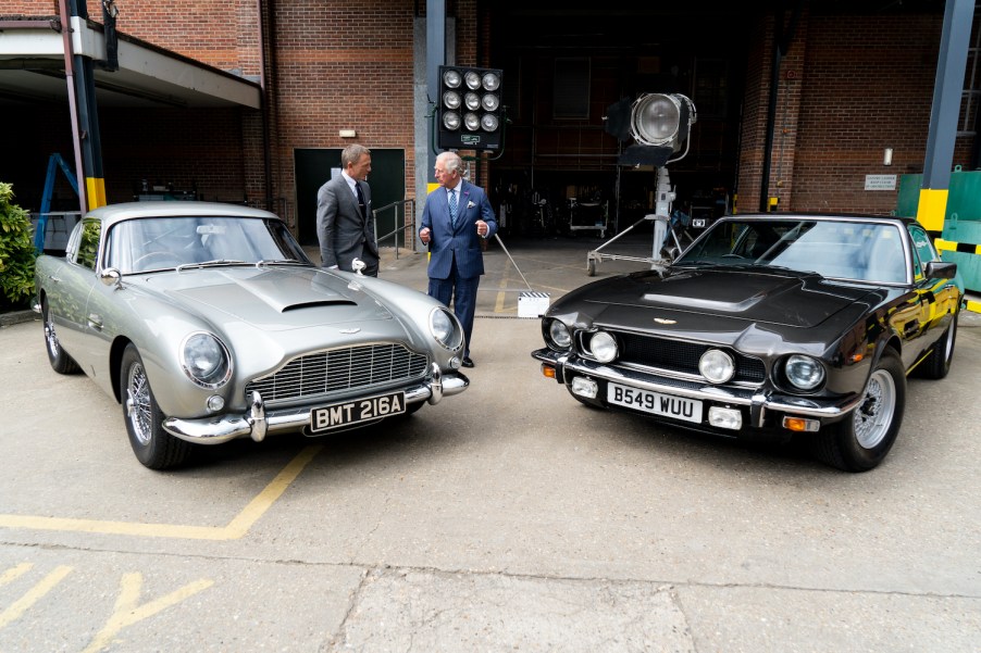 James Bond actor Daniel Craig showing Prince Charles two Aston Martin cars from No Time To Die