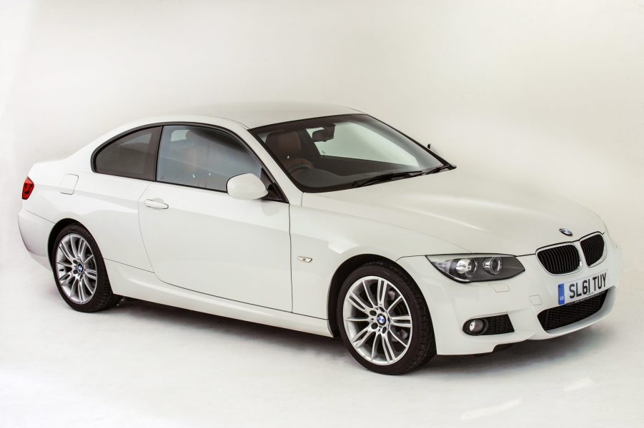 A white 2011 BMW 335i coupe is a hell of a luxury car, seen here in white shot from the front 3/4 view