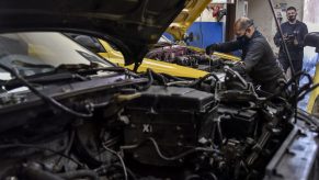 Men work in a mechanic's shop in Columbia