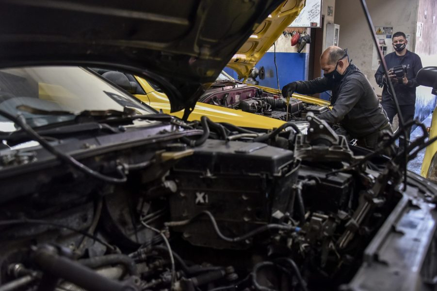 Men work in a mechanic's shop in Columbia