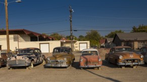 used cars, rusted trucks