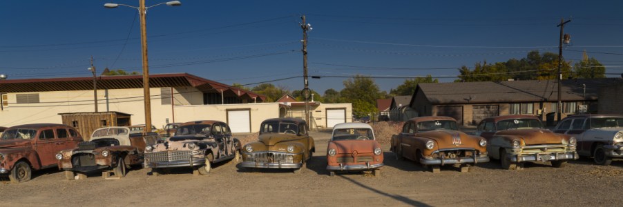 used cars, rusted trucks