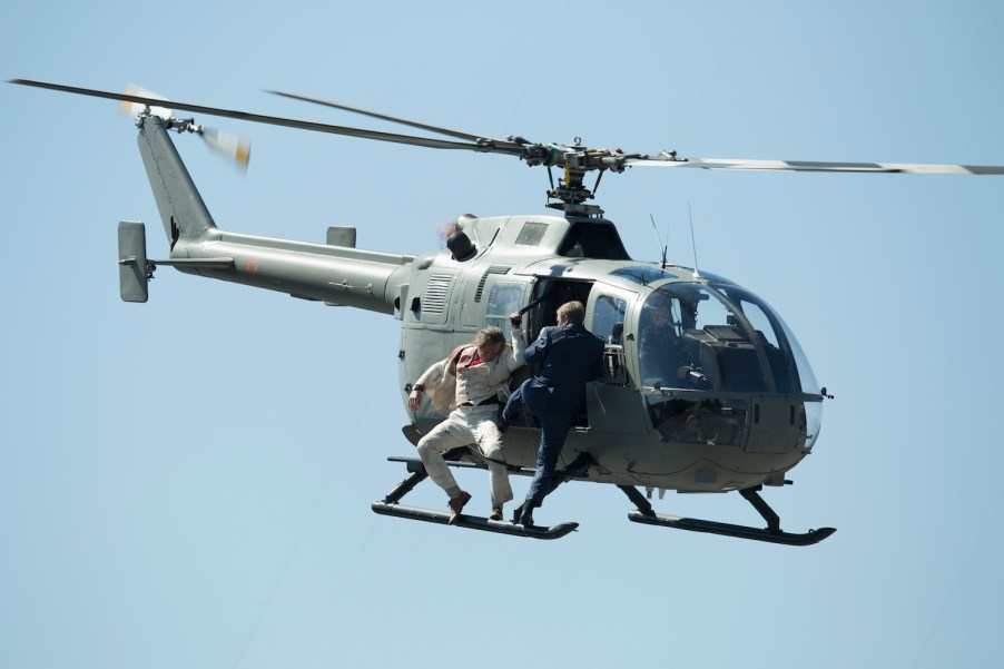 This is a picture of stuntmen as they perform a battle hanging from a helicopter during the filming of the James Bond movie 'Spectre' at Zocalo Main Square in Mexico City, Mexico. The Spectre fight is one of many memorable James Bond helicopter scenes. | Miguel Tovar/LatinContent/Getty Images