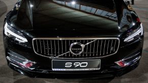 A black Volvo S90 shot from the hood down at an auto show