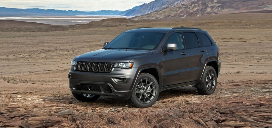 A dark gray Jeep Grand Cherokee in the desert.